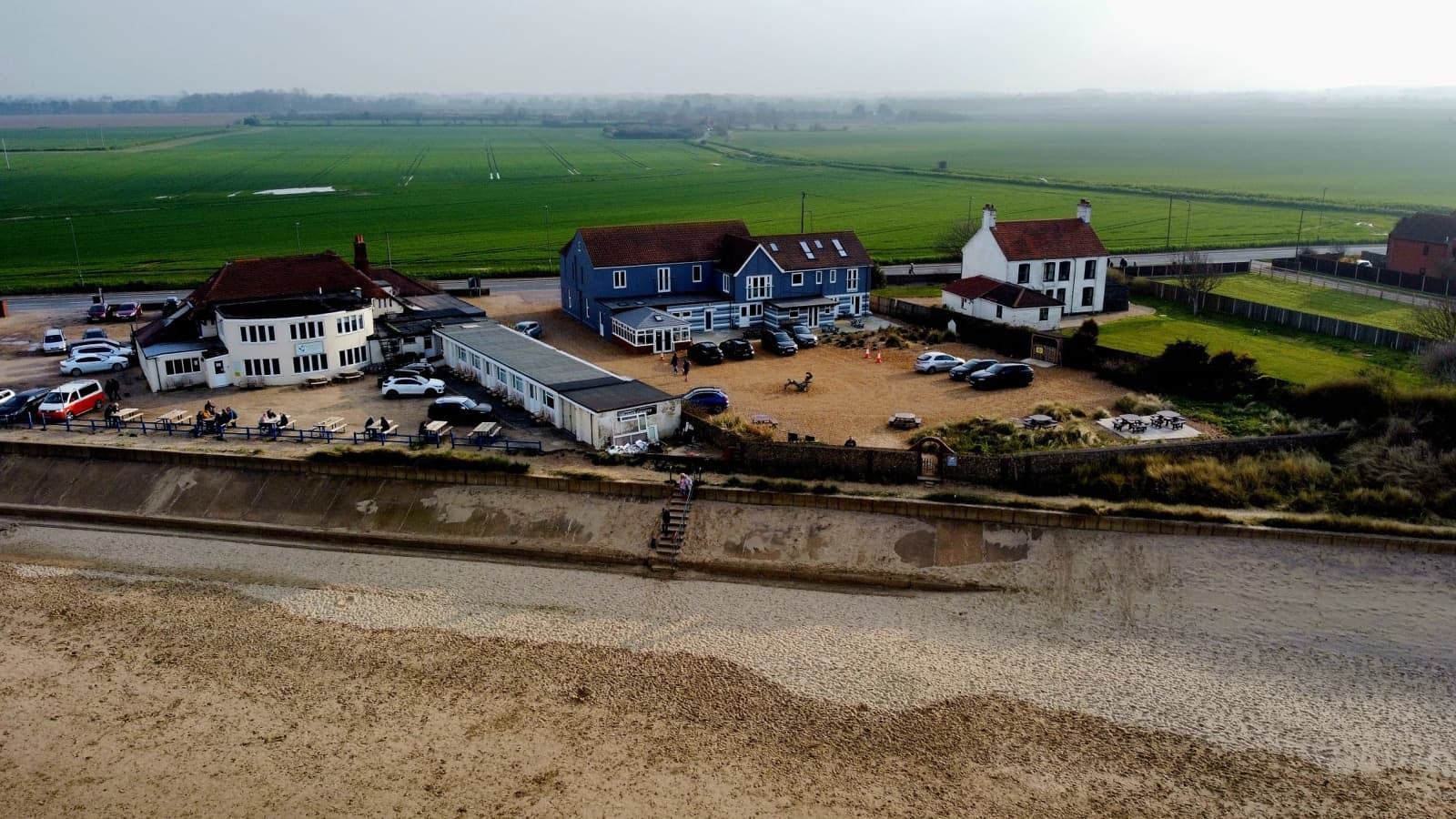 A side aerial view of Seals Bacton and the nearby beach