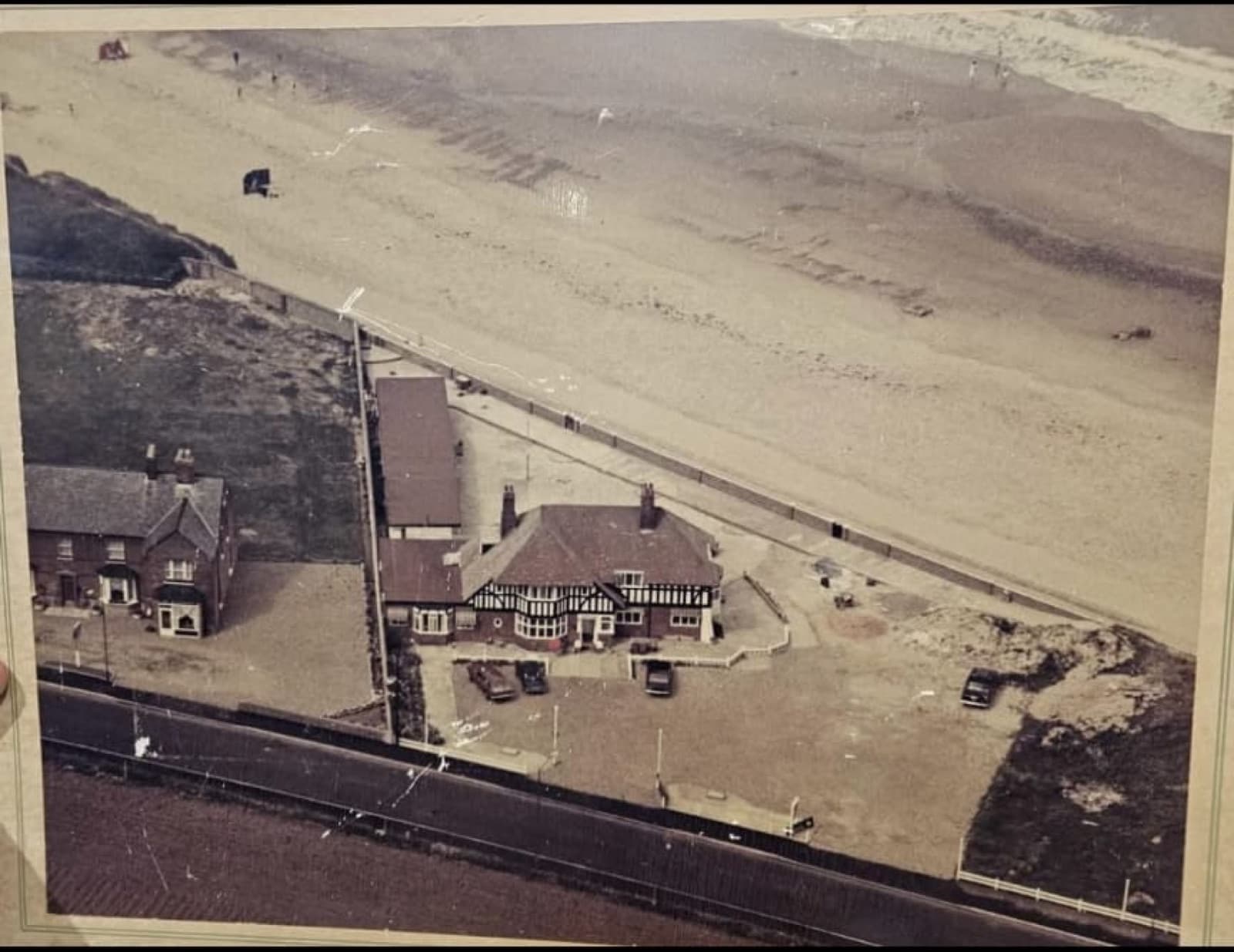 A historic aerial view of Seals Bacton beside the coast