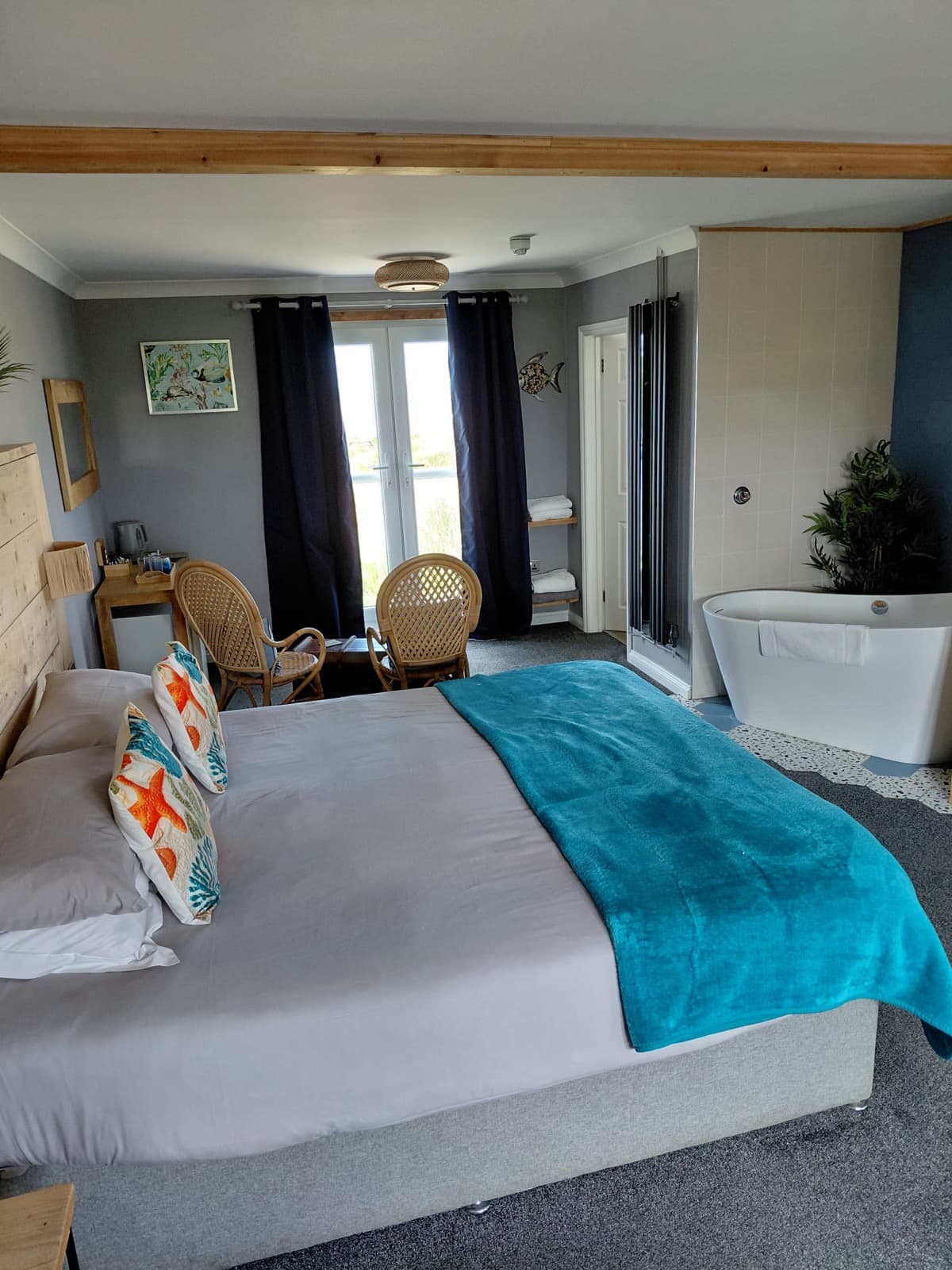 A sea view double room at Seals Bacton with turquoise accents